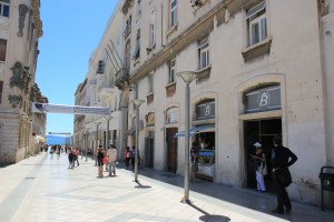 Doors to apartment 3rd on right opening onto an impressive street .
